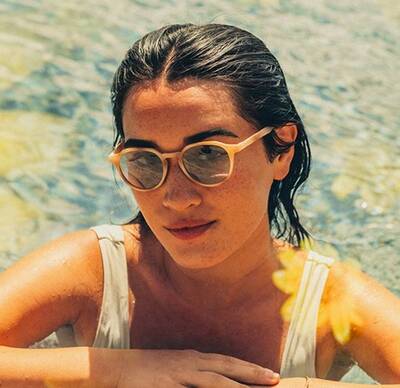 Sunglasses from the Sunski Spring 2024 Collection worn by woman in pool